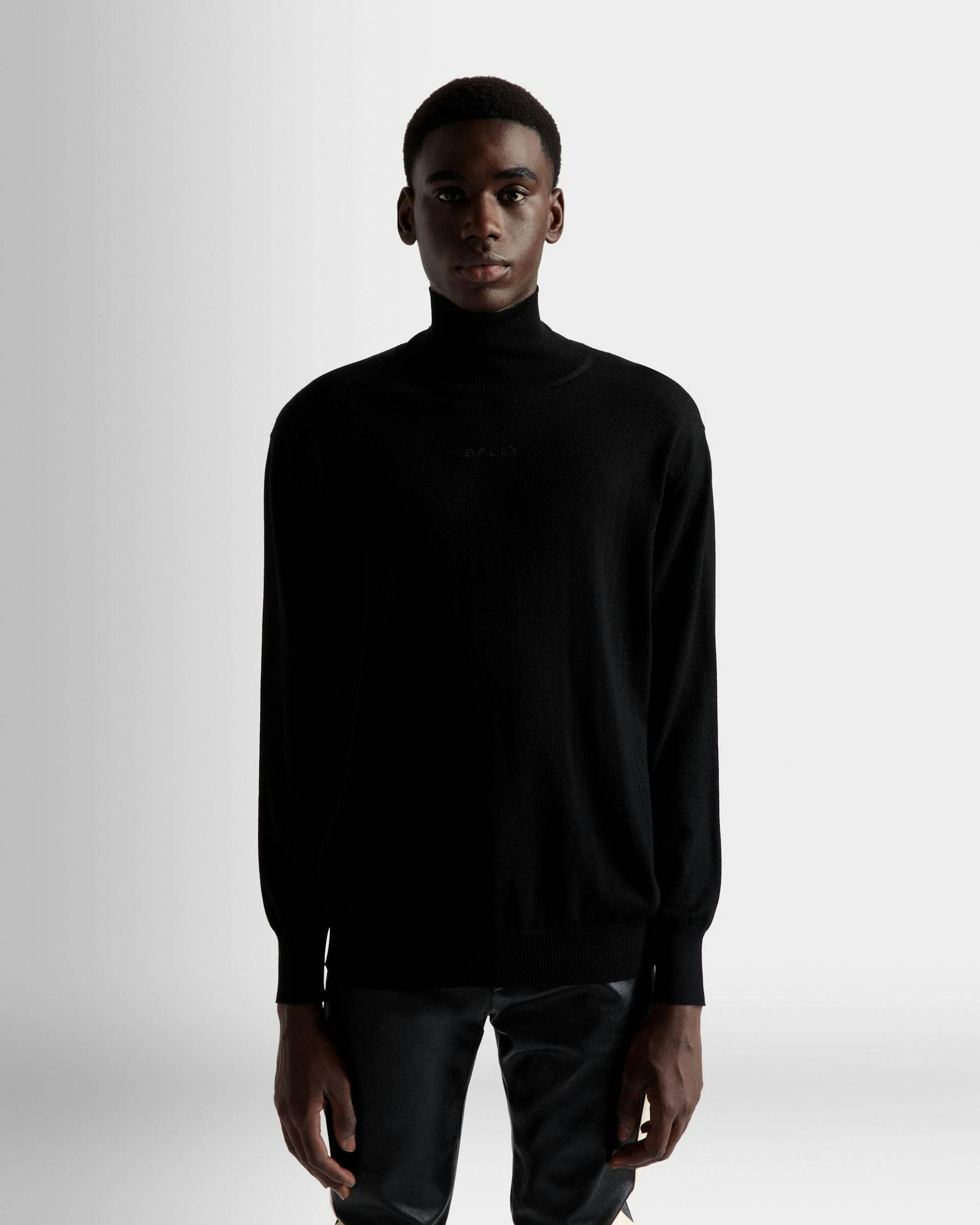 Men's Roll Neck Sweater In Black Wool | Bally | On Model Close Up
